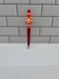 Stylo bille perlé - Acrylique orange avec fleur décorative